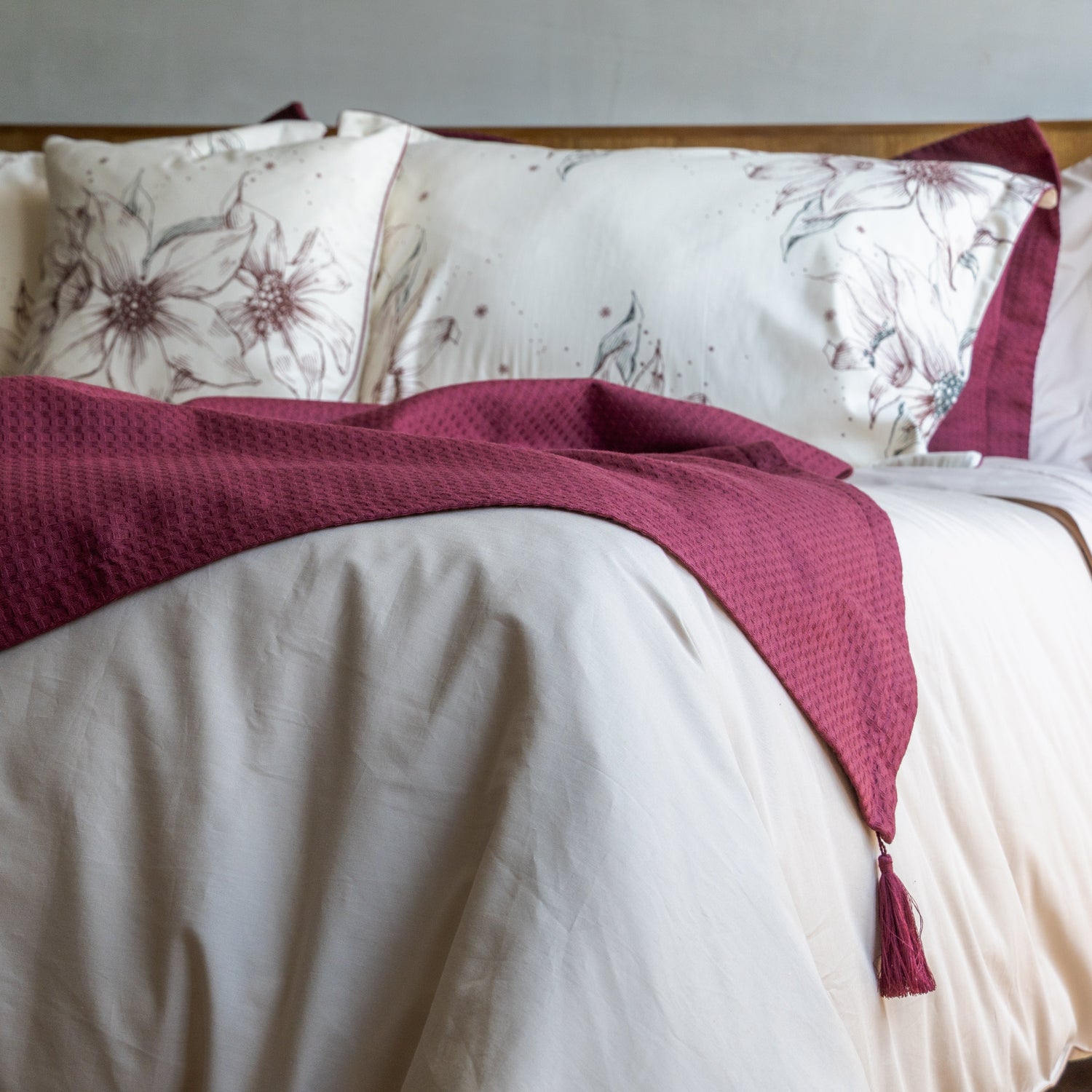 Manta piquet decorativa con borlas Vinotinto